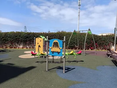 a playground with three play equipment in a park at Appartement la Siesta beach resort Mohammedia in Mohammedia