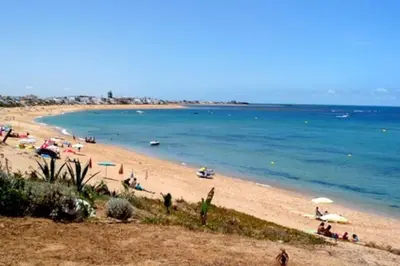 a beach with a bunch of people on it at Appartement bien situé Dahomey city . Bahia beach in Bouznika