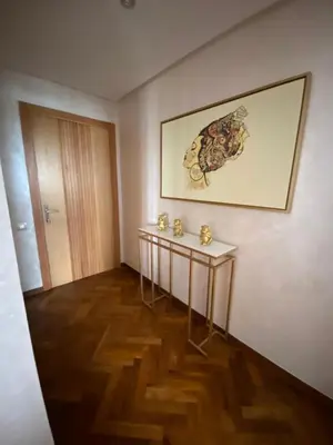 a room with a table and a picture on the wall at Casa finance city apartment in Casablanca