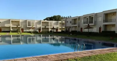 a large swimming pool in front of a building at Bel appart à Hacienda Beach Sidi Rahal in Sidi Rahal