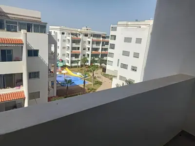 a view of a pool from the balcony of a building at luxu appart siesta beach resort in Mohammedia