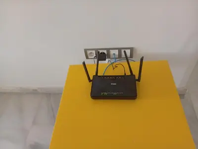 a laptop sitting on top of a yellow table at luxu appart siesta beach resort in Mohammedia