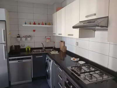 a kitchen with a sink and a stove top oven at luxu appart siesta beach resort in Mohammedia