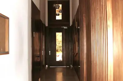 a hallway with wood paneled walls and a door at SUITE APPARTEMENT BOURGOGNE 2 pièces in Casablanca