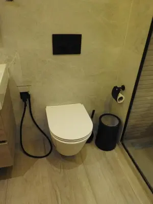 a bathroom with a toilet and a trash can at Anfa Place, Art Deco Luxury Apartment, Sunny Ocean View in Casablanca