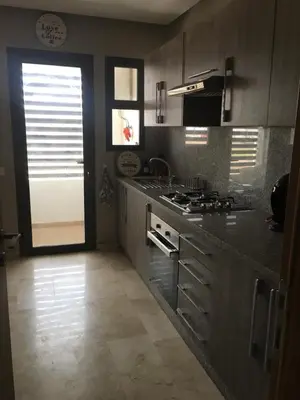 a kitchen with a stove and a counter top at LUXURY 3 bedroom apartment with pool, Nouaceur, Morocco in Derroua