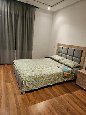 a bedroom with a bed and a dresser and a window at LUXURY 3 bedroom apartment with pool, Nouaceur, Morocco in Derroua