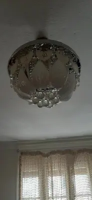 a chandelier hanging from a ceiling with a window at Apartment in the center of Casablanca in Roches Noires