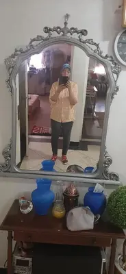 a woman taking a picture of herself in a mirror at Apartment in the center of Casablanca in Roches Noires