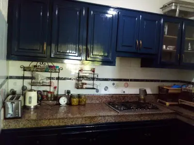 a kitchen with blue cabinets and a counter top at Mesdunes in Azemmour