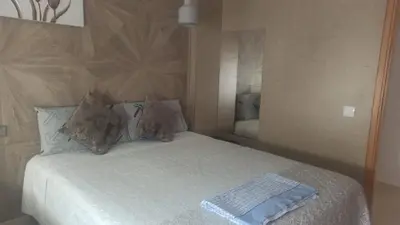 a bedroom with a white bed with a mirror at Aryam Room in Rabat