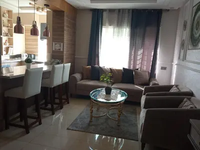 a living room with a couch and a table at Aryam Room in Rabat