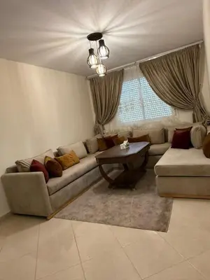 a living room with a couch and a table at Magnifique Appartement avec Piscine à Tamaris in Tamaris