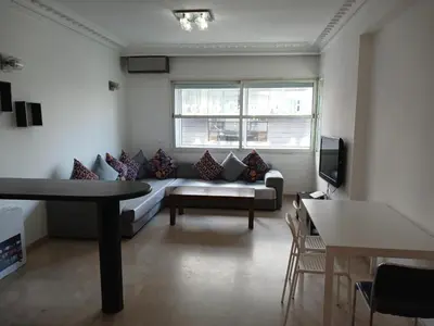 a living room with a couch and a tv at Gauthier confort in Casablanca