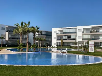 an empty swimming pool in front of a building at Appartement blanca beach Sidi Rahal accès direct à la plage in Casablanca