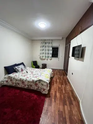 a bedroom with a bed and a red rug at 2mars in Casablanca