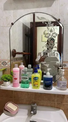 a bathroom sink with a bunch of bottles of soap at 2mars in Casablanca