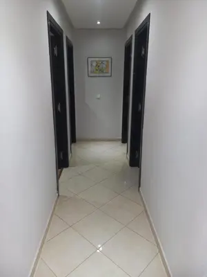 a hallway with black doors and a tile floor at Beach-Side 2-BR Oasis with Private Pool & Parking in Casablanca