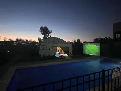 a large building with a tv and a swimming pool at American Farm Villa Grand Casablanca/El Jadida in Zaouia Sidi Bou Azza