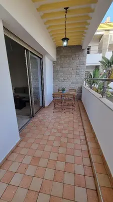 a patio with a table and chairs on it at My Cosy Place Rabat - Skhirat 2min de la plage avec Piscine in Skhirat