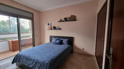 a bedroom with a blue bed and a window at My Cosy Place Rabat - Skhirat 2min de la plage avec Piscine in Skhirat