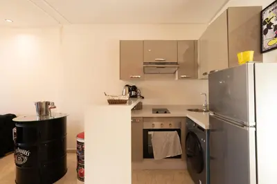 a kitchen with a refrigerator and a washer and dryer at La cascade de Maryline in Casablanca