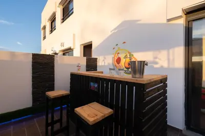 a bar with two stools next to a building at La cascade de Maryline in Casablanca