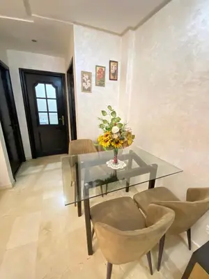 a dining room with a glass table and chairs at Appartement de lux in Casablanca