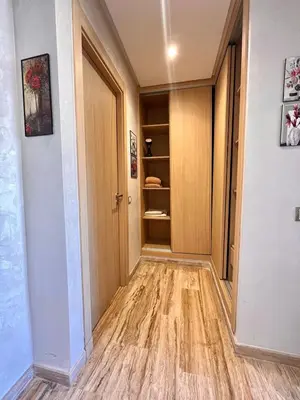 a hallway with a wooden door and a closet at Studio et place parking gratuite in Casablanca