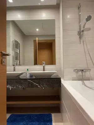 a bathroom with two sinks and a large mirror at Luxury Flat in Casa Finance City in Casablanca
