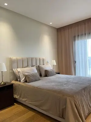a large bed in a bedroom with a window at Luxury Flat in Casa Finance City in Casablanca