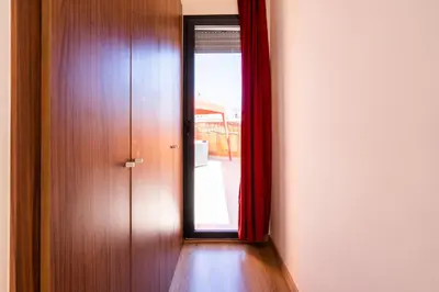 a hallway with a door and a red curtain at Terrasses de Marrakech- Au coeur de Casablanca in Casablanca