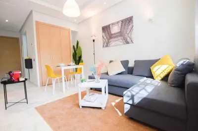 a living room with a couch and a table at YourPlace - Prestigia - Hay Riad in Rabat