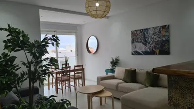 a living room with a couch and a table at appartement de luxe front mer à DAR BOUAAZA in Dar Bouazza