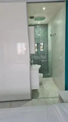 a bathroom with a shower and a toilet and a sink at appartement de luxe front mer à DAR BOUAAZA in Dar Bouazza
