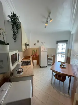 a kitchen with a table and a counter top at Appartement standing spacieux Casablanca in Casablanca