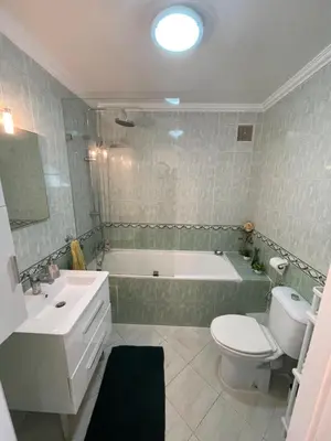 a bathroom with a tub and a toilet and a sink at Appartement standing spacieux Casablanca in Casablanca