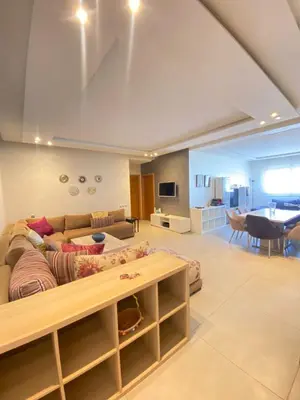 a living room with a couch and a table at Bright and Comfortable Stay by Stade Mohammed V in Casablanca