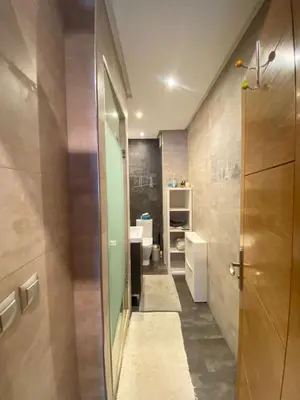 a small bathroom with a sink and a toilet at Bright and Comfortable Stay by Stade Mohammed V in Casablanca