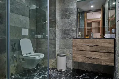 a bathroom with a toilet and a glass shower at TheCasaEdition - Bel Azur - Sea View & Hassan II Mosqué Residency in Casablanca