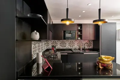 a kitchen with black cabinets and a black counter top at TheCasaEdition - Bel Azur - Sea View & Hassan II Mosqué Residency in Casablanca