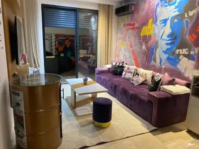 a living room with a purple couch and a table at Chez Bebel in Casablanca