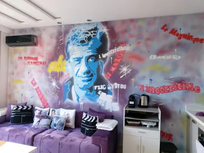 a living room with a purple couch in front of a mural at Chez Bebel in Casablanca