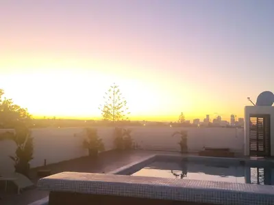 a swimming pool with the sunset in the background at Chez Bebel in Casablanca