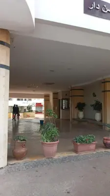 a lobby with potted plants in pots in a building at Bel Appartement spacieux 3 pièces avec double salon Paisible & Proche de la Gare d'Agdal in Rabat