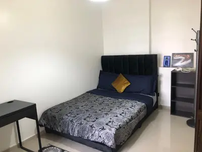 a bedroom with a bed with blue and yellow pillows at Bel Appartement spacieux 3 pièces avec double salon Paisible & Proche de la Gare d'Agdal in Rabat