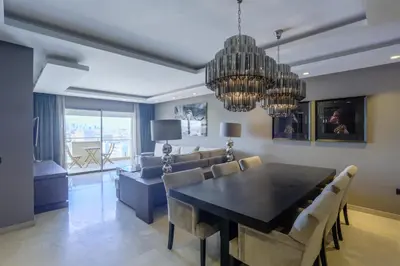 a dining room with a table and a couch at W-Aldorf in Casablanca