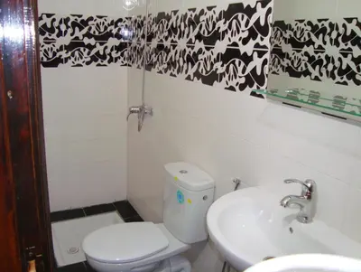 a bathroom with a toilet and a sink at Yasmine Appartements in Temara