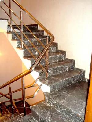a set of stairs with a metal railing at Yasmine Appartements in Temara