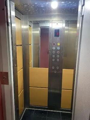 a elevator in a bathroom with a mirror at HOTEL AL MAMOUN in Casablanca